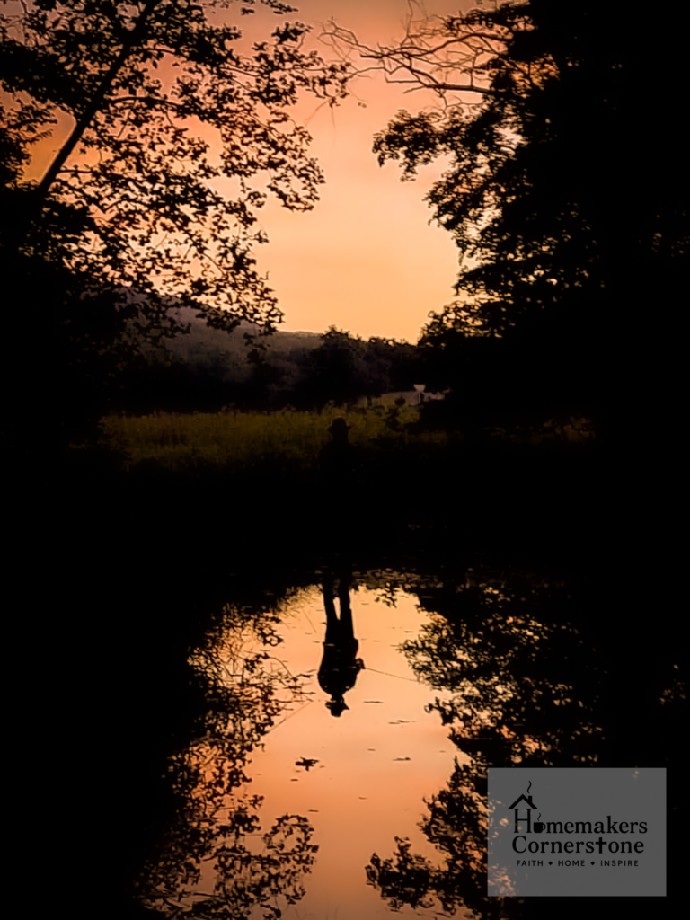 Dark Depths of the Mind: Finding God in the Darkness Sunset over a creek with a fishing mans reflection in the water
