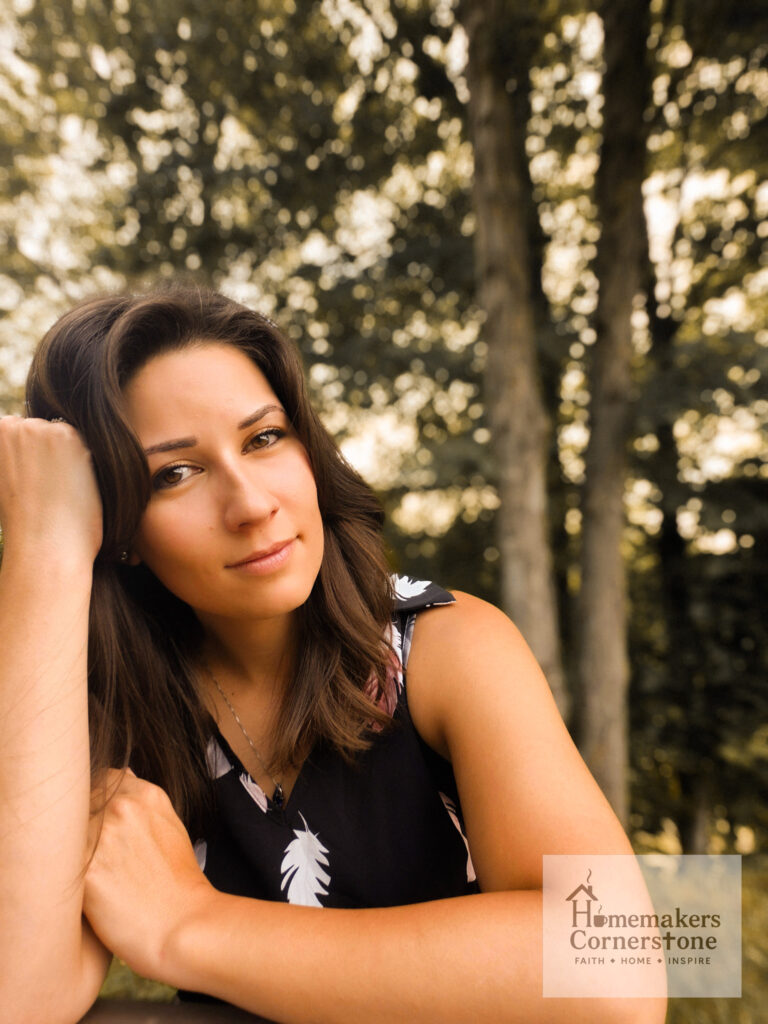 Amelia Robertson, creator of Homemakers Cornerstone sitting outside.